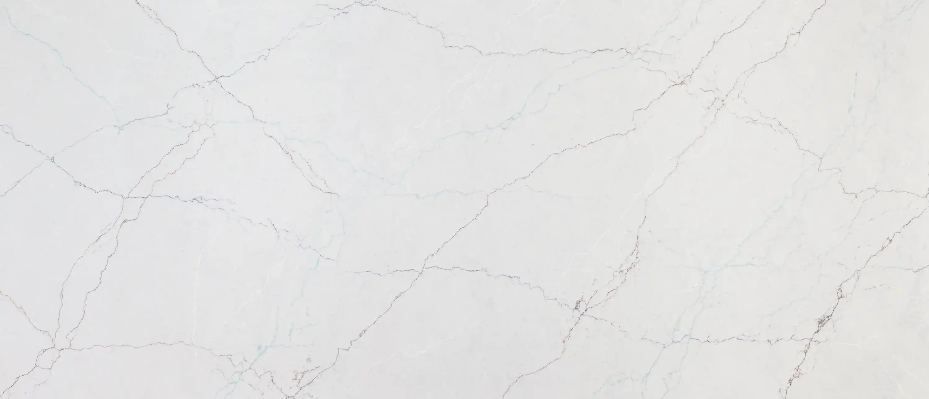 A white quartz slab with thin gray veins