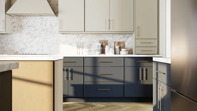 Close view of deep blue lower cabinets, cream upper cabinets and a wood end panel under a marble backsplash