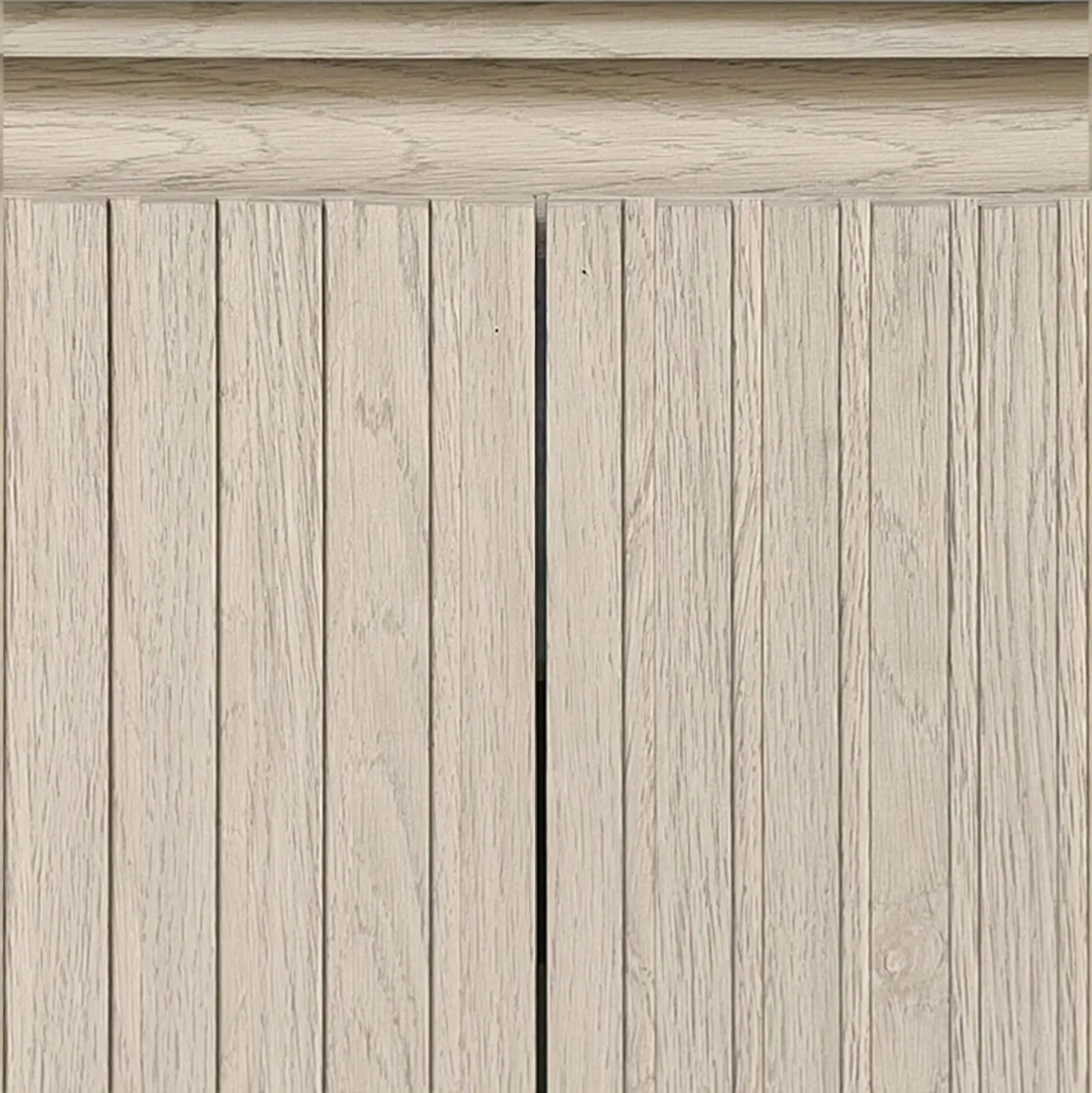 Close-up of the grooved, handle-free fluted doors in a light oak finish on the vanity
