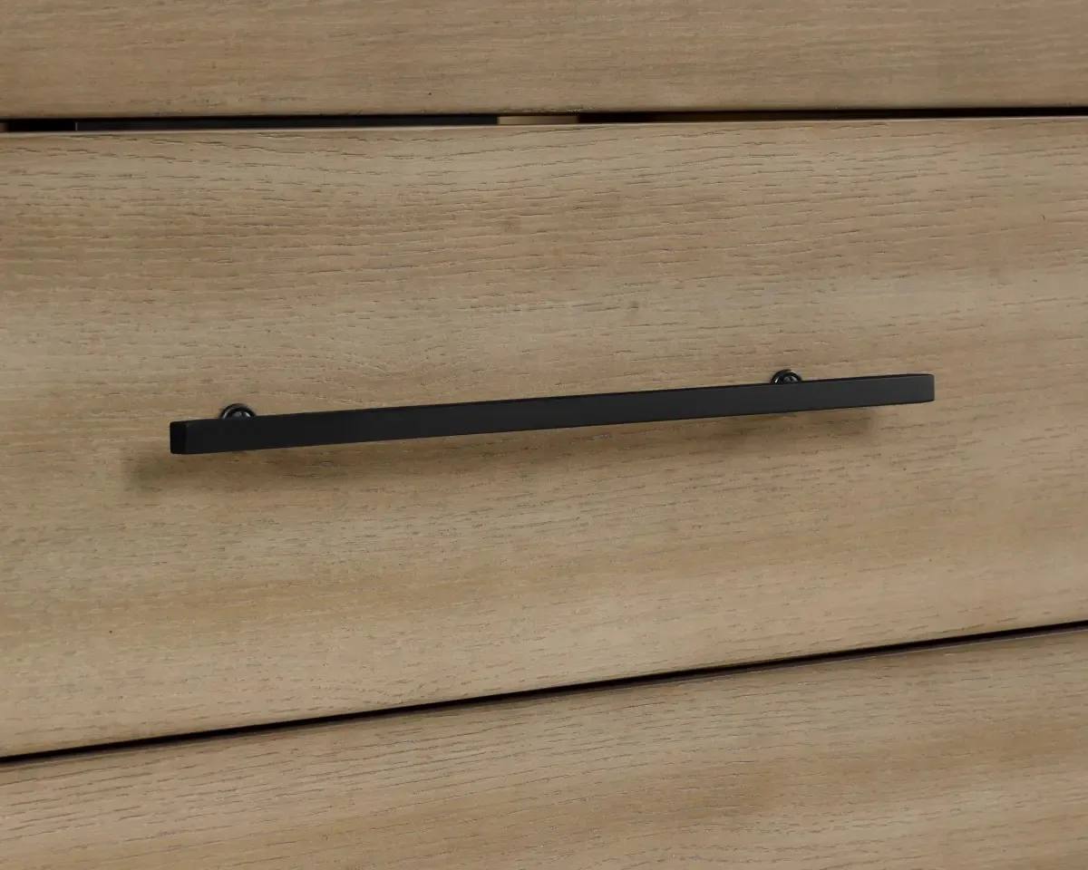 Matte black bar handle on the vanity's light wood-grain drawer front