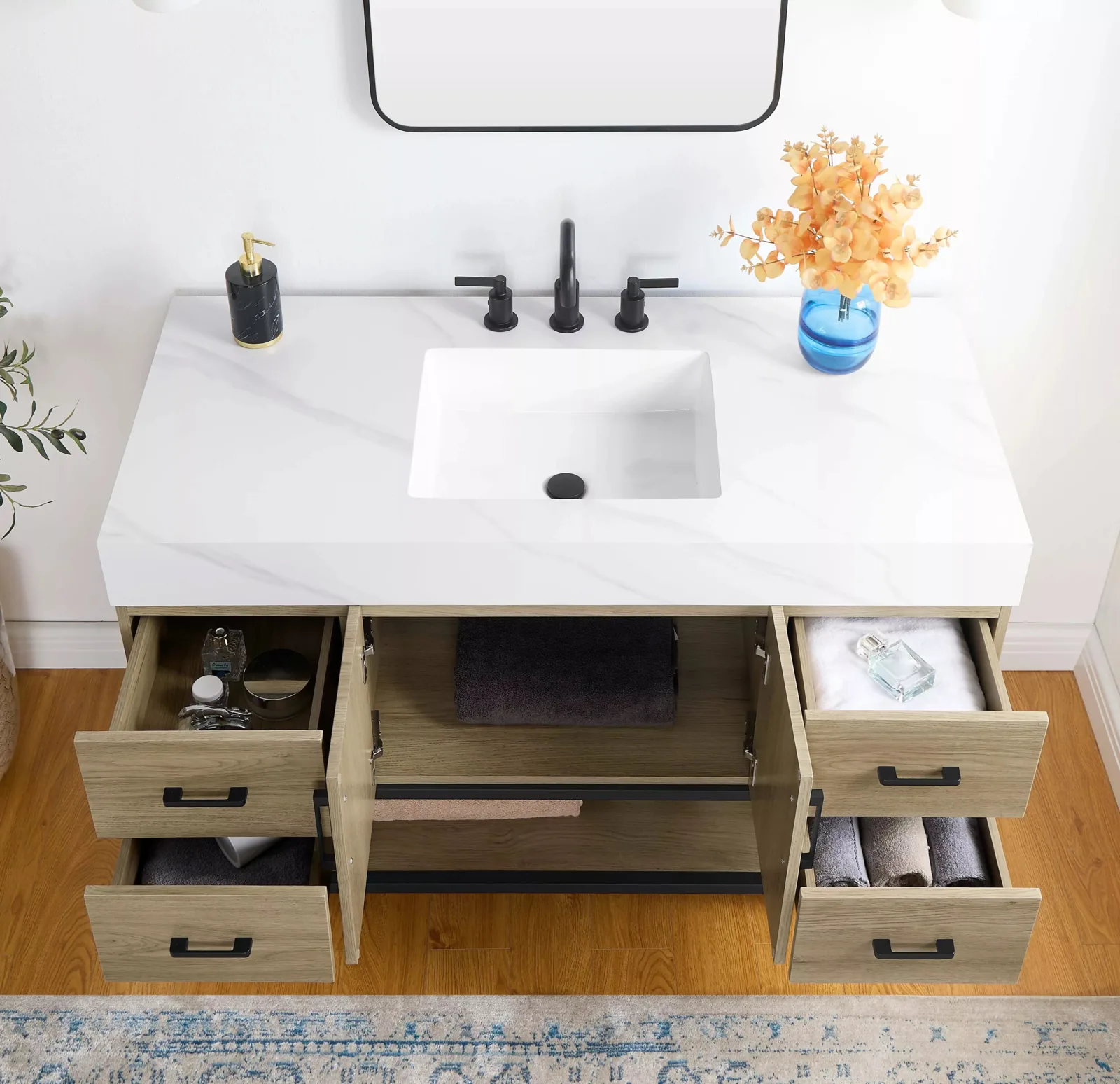 48-inch freestanding vanity with its drawers and doors open under the Calacatta sintered stone top