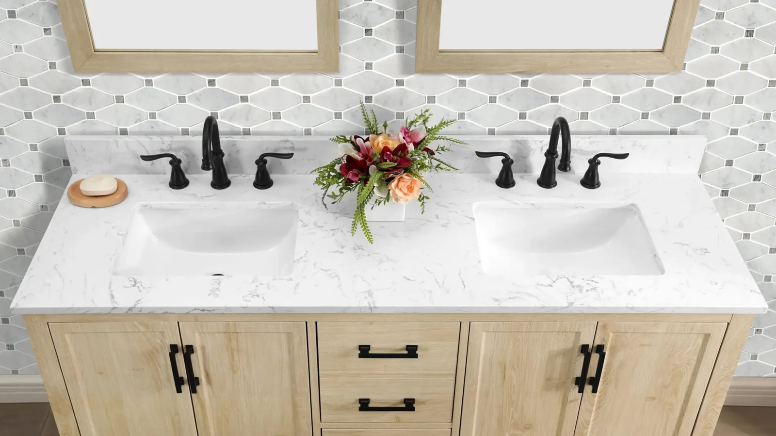 Close view of a double vanity top with two white sinks and black faucets