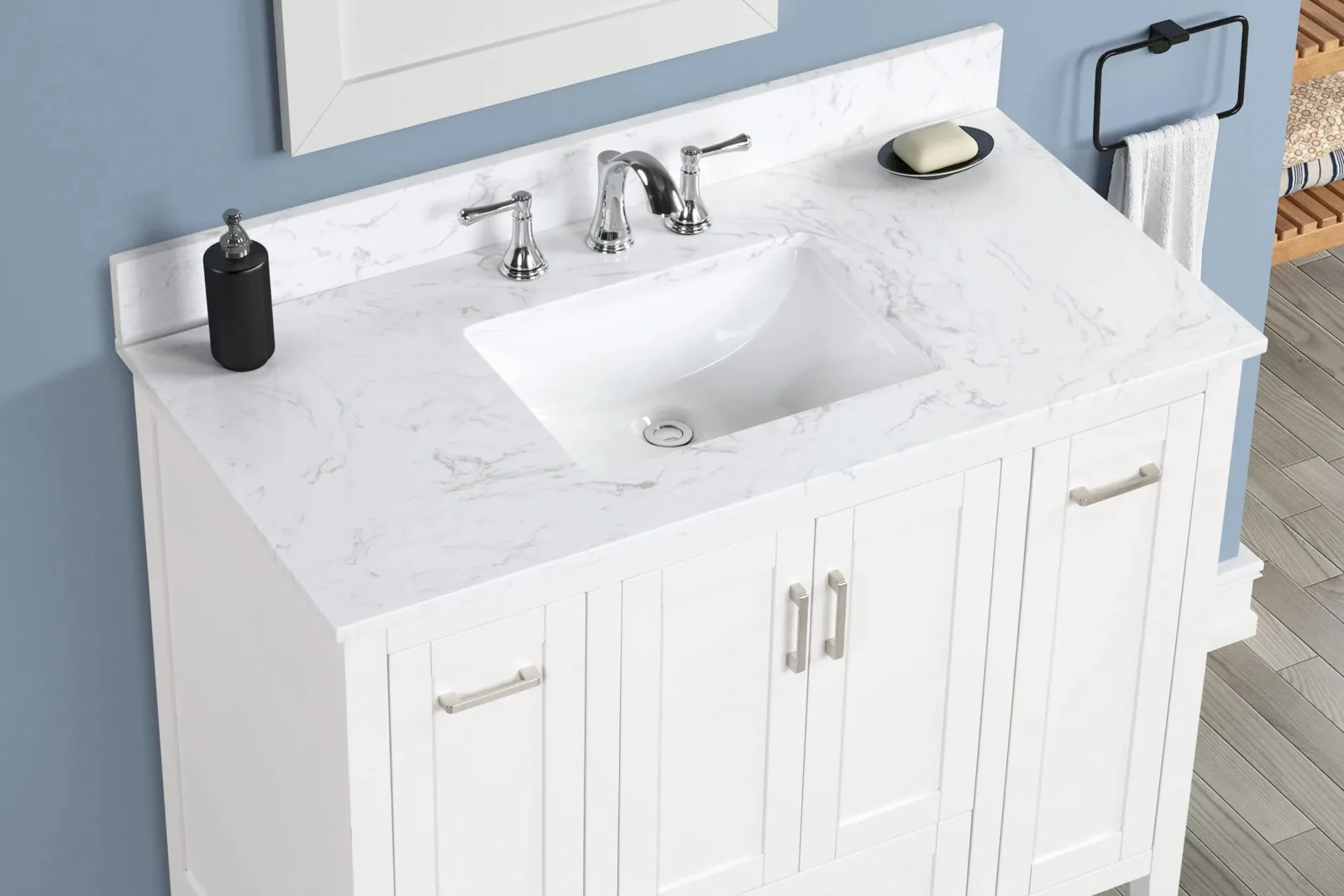 Close-up of the Carrara engineered stone top with rectangular undermount sink and widespread faucet