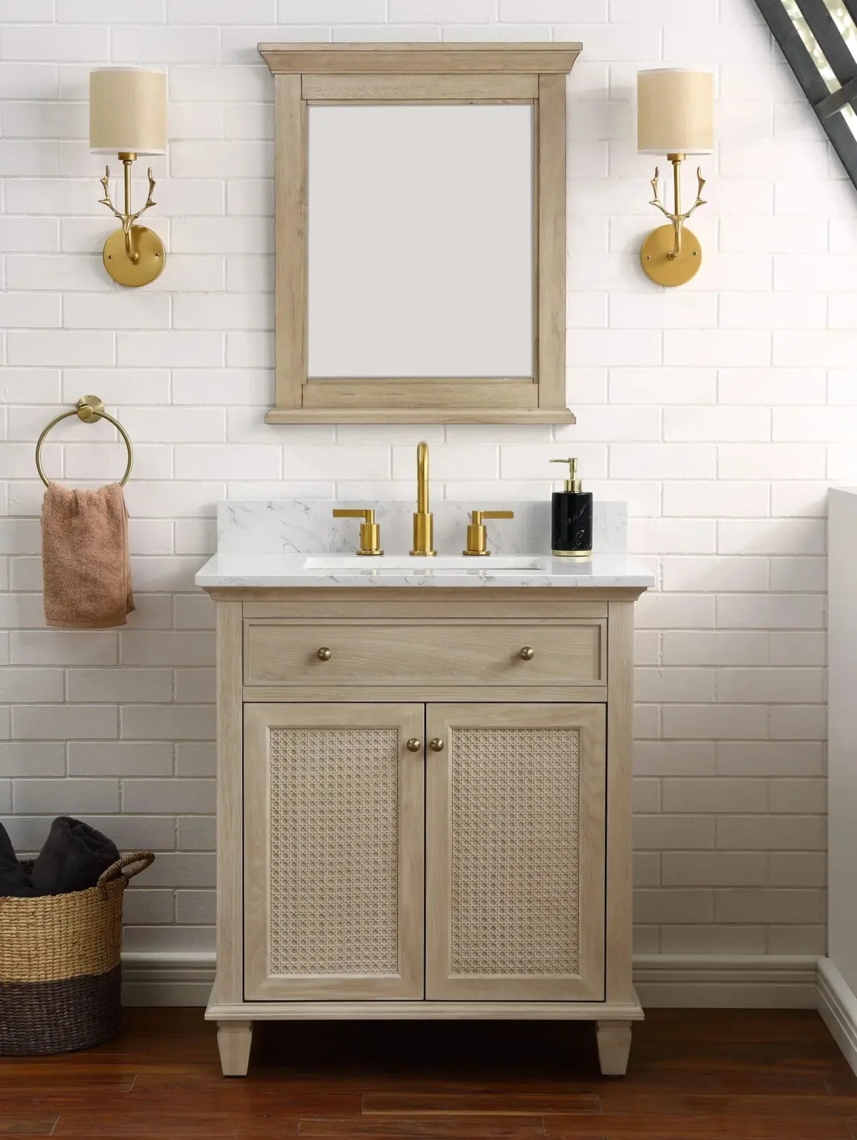 30-inch natural wood vanity with cane doors and Carrara top in a white-tiled bathroom